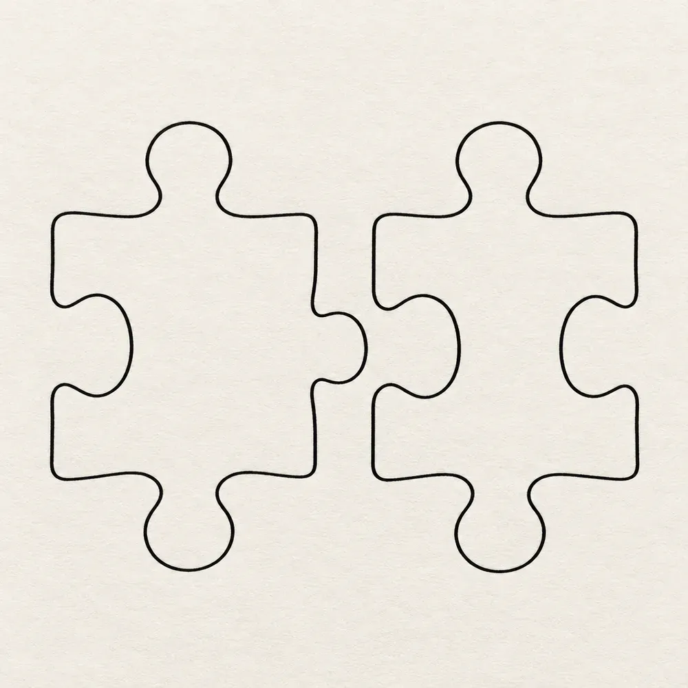 Two jigsaw pieces side by side, cut so that they would fit together.